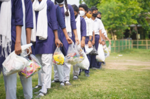 a group of people holding plastic bags