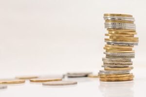 a stack of coins on a white surface