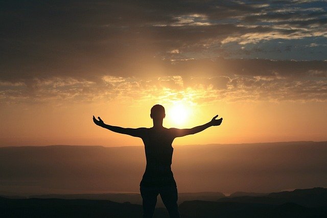 a man infront of morning sun